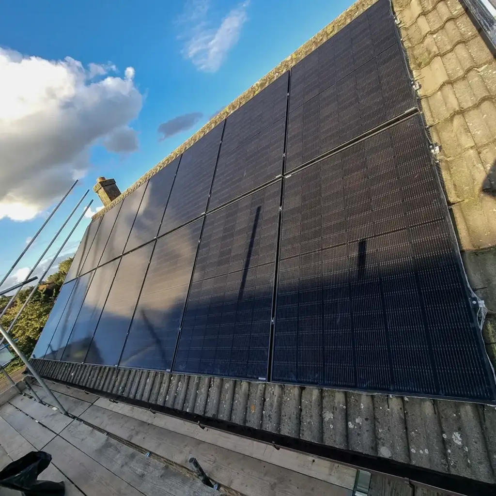Black photovoltaic panels on a pitched tiled roof