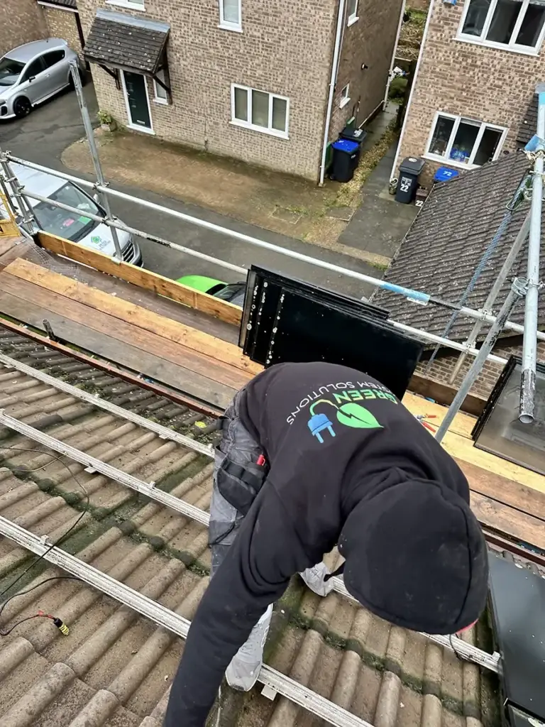 Green System Solutions installer working on rooftop mounting rails